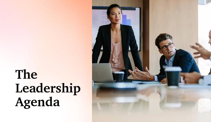 Business team gathered around a conference table, reviewing information and talking. Business team gathered around a conference table, reviewing information and talking.