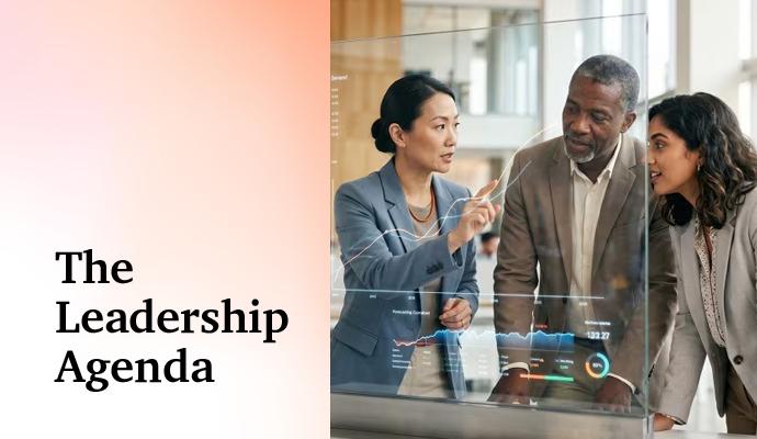 A group of colleagues discusses data displayed on a transparent screen as one person points toward the information. A group of colleagues discusses data displayed on a transparent screen as one person points toward the information.