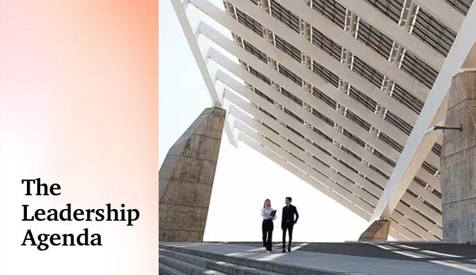 A man and woman in business attire stand on wide steps under a massive geometric canopy with the words "The Leadership Agenda" superimposed A man and woman in business attire stand on wide steps under a massive geometric canopy with the words "The Leadership Agenda" superimposed